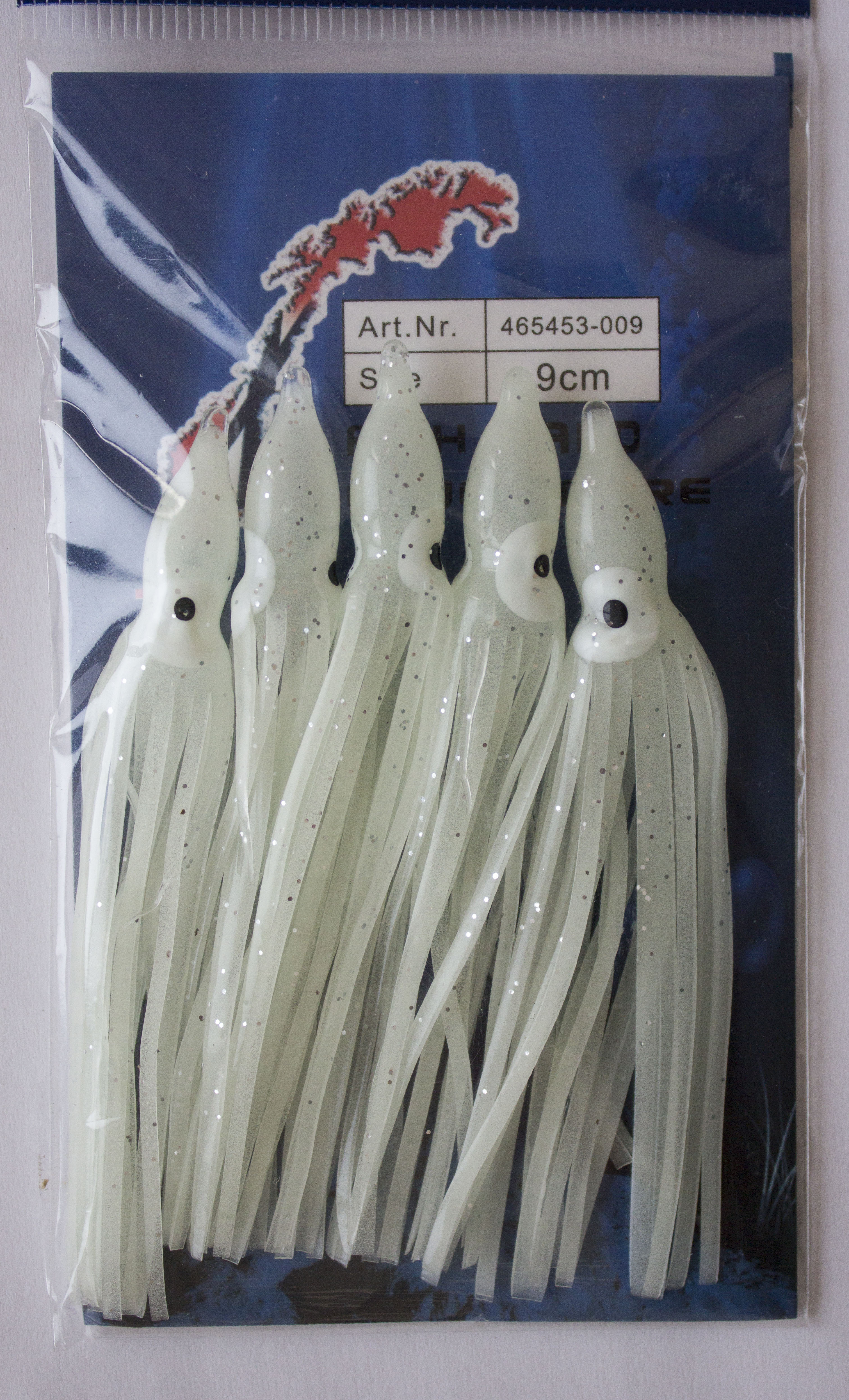 Packung mit 9 cm langen Angelködern mit Tintenfischrock zum Salzwasserangeln, mit silbernen Glitzerakzenten und realistischem Tentakeldesign. – Fishing Adventure GmbH